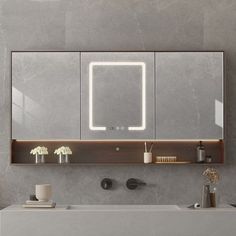 a bathroom with a sink, mirror and lights on the wall above it's counter