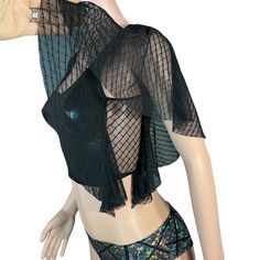 Unleash your inner star with our dazzling Metallic Crop Tank with Mesh Flutter Sleeves. Perfect for raves, festivals, aerial performances, pole fitness, or as a statement everyday top, this unique piece combines edgy fashion with ultimate comfort.Key Features: Eye-Catching Design w/ metallic Fabric: Made from high-quality, metallic material that shines with every movement, ensuring you capture the spotlight wherever you go. Mesh Flutter Sleeves: Delicate, airy mesh flutter sleeves add a touch of whimsy and elegance, creating a dynamic contrast with the metallic fabric.Comfortable and Flattering Fit Cropped Length: The stylish cropped cut sits perfectly above the waist, flattering your figure and pairing effortlessly with high-waisted bottoms. Stretch Fabric: Crafted with a blend of stretch Metallic Mesh, Pole Fitness, Ruffle Shirt, Metallic Fabric, Mesh Sleeves, Flutter Sleeve Top, Black Metallic, Flutter Sleeves, Edgy Fashion