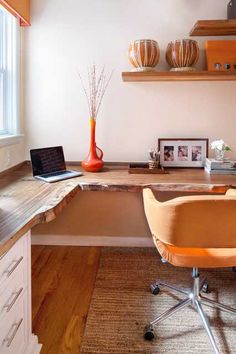 an office with a desk, chair and laptop on the counter top in front of a window