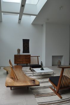 a living room filled with furniture and a skylight