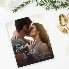 save the date card with an image of a man kissing a woman's forehead