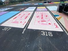 the parking lot has been painted with different colors and numbers for cars to pass by