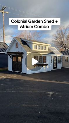 a small white building sitting in the middle of a parking lot