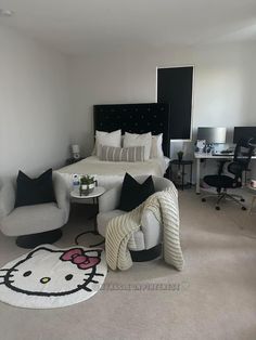 a bedroom with a hello kitty rug on the floor and two chairs in front of the bed