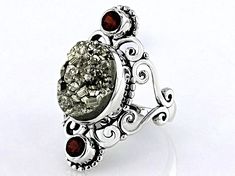 Artisan Collection of India™  12.98ct Oval Pyrite & 0.40ctw Round Garnet Sterling Silver Ring. Measures Approximately 0.81"L x 1.24"W. Not Sizeable. Fusion Oval Jewelry With Accent Stones, Oval Fusion Jewelry With Accent Stones, Formal Fusion Rings With Accent Stones, Formal Fusion Style Rings With Accent Stones, Fusion Multi-stone Jewelry For Anniversary, Fusion Style Round Gemstones With Accent Stones, Luxury Silver Gemstones For Wedding, Fusion Style Multi-stone Jewelry For Anniversary, Formal Fusion Jewelry With Accent Stones