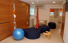 a living room filled with furniture and a blue ball