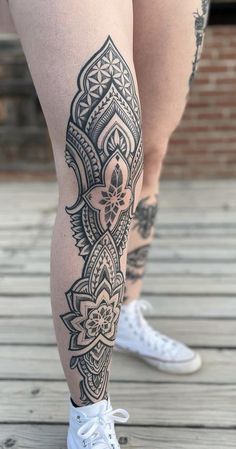 a woman's legs with tattoos on them