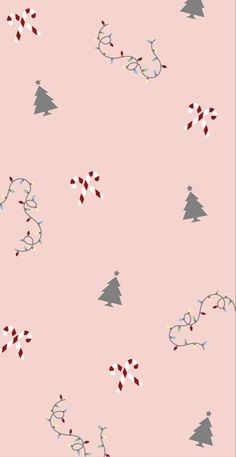 a pink wallpaper with christmas trees and candy canes on the bottom right corner