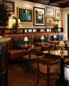 a restaurant with tables and chairs, pictures on the wall