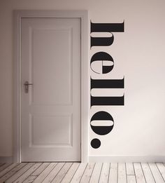 an open door with the word utopia painted on it in black and white, next to a doorway