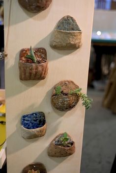 there are many small pots on the wall