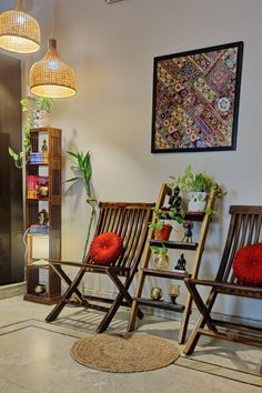 two wooden chairs sitting next to each other in a room