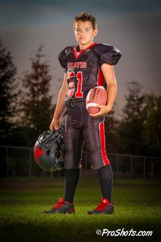 a football player holding a ball and glove