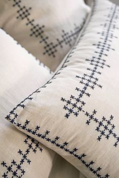 two white pillows with black crosses on them