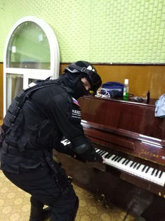 a police officer is playing the piano