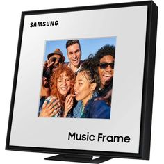 the samsung frame has an image of people smiling and posing for a photo on it