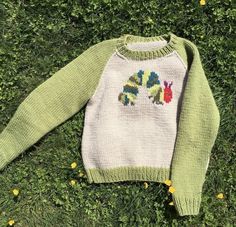 a sweater that is laying in the grass