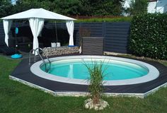 an above ground pool with a gazebo next to it