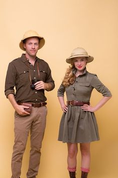 two people standing next to each other with hats on their heads and one holding a camera