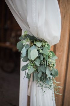 an image of a wedding dress with greenery on it