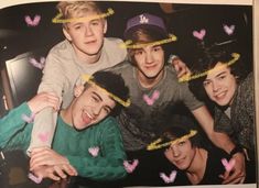 a group of young men standing next to each other with hearts drawn on their foreheads