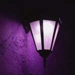 a purple light shines brightly in the dark