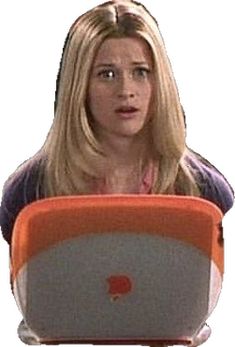 a woman sitting in front of a laptop computer with a surprised look on her face