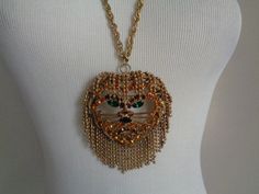 "Vintage DOMINIQUE Unsigned Adorable Hairy Lion Head Face Golden Fringe Balls Chain Jeweled W/Orange Amber Green Purple Black Crystal Accents Brooch Pendant With Gold Tone Chain Necklace Vintage Circa 1960's 1970's Rare Book-Piece Unsigned DOMINIQUE Fanciful Hairy Lion Head Face Golden Fringe Balls Chain Jeweled With Orange Amber Green Purple and Black Crystal Rhinestones Accents 2in1 Art Pin Brooch or Pendant With Gold Tone Chain/Link Necklace Stunning and Very Dramatic Art Piece!... This fanci Gold Jeweled Costume Chain Necklace, Luxury Yellow Bohemian Necklaces, Lion Necklace Women, Lion Brooch, Lion Head Necklace, Book Pieces, Crystal Brooch, Lion Head, Chain Link Necklace