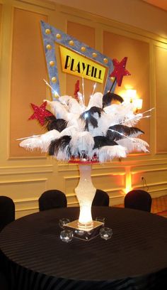 the centerpiece is decorated with white feathers and red, black, and blue decorations