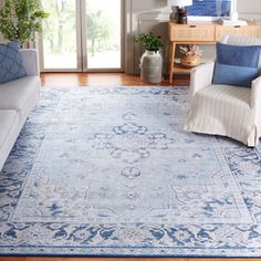 a living room filled with furniture and a blue rug