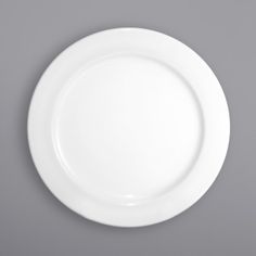 an empty white plate on a gray background