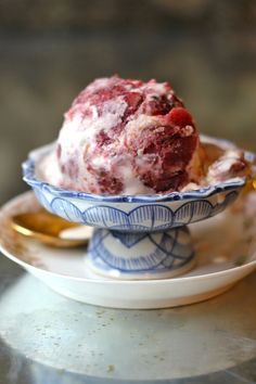 a bowl filled with ice cream sitting on top of a table