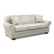 a white couch with two pillows on it