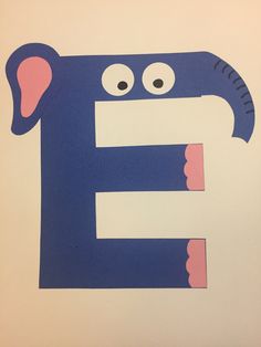 the letter e is made up of paper with eyes and ears on it's face