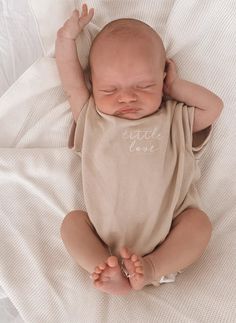 Comfort meets style with our oversized embroidered 'Little Love' Romper. Made from breathable & soft unlined cotton fabric, it is the perfect gender-neutral piece for your little love. Featuring snap buttons on the neck for easy changing. Available in size NB-2Y. Beige with white embroidery. Made from 100% cotton. CARE Cold Gentle Machine Wash.Do Not Soak Or Bleach.Dry Flat In Shade.Do Not Tumble Dry. Unisex Cute Tops For Loungewear, Beige Short Sleeve Tops For Playtime, Beige Cotton Tops For Playwear, Beige Cotton Tops For Playtime, Beige Tops For Playwear In Spring, Beige Tops For Spring Playwear, Family Matching Cotton Tops For Loungewear, Embroidered Cotton Top For Playtime, Cream Cotton Tops With Embroidered Text