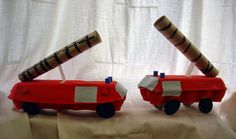 two toy cars made to look like they are going through the same direction with each other