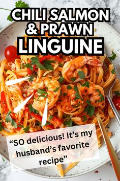 a white plate topped with pasta and shrimp on top of a marble table next to a fork