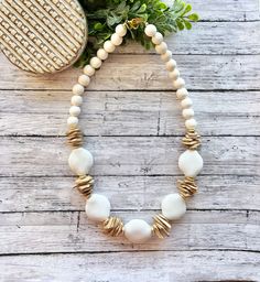 Beautiful white beaded necklace made with white ceramic chunky beads, coconut chip beads and white wood beads.  It measures approximately 22-23 inches with a lobster clasp. Need a different length? just send me a message! Thanks so much for stopping by Beaded Blues! White Heishi Beads Jewelry With Large Beads, White Beach Jewelry With Wooden Beads, White Wooden Beads Jewelry For The Beach, White Wooden Beaded Necklaces For Beach, White Wooden Beads Jewelry For Beach, White Heishi Beaded Jewelry, Unique White Necklaces With Wooden Beads, White Wooden Beaded Necklaces, White Bohemian Shell Necklace With Wooden Beads