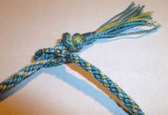 a piece of blue and yellow rope on top of a table