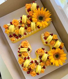 the cake is decorated with flowers and fruit in the shape of the number 50,