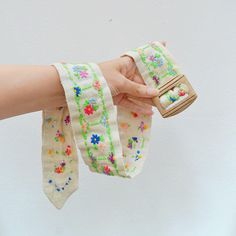 A sweet circa 1960s belt, lovingly handmade from pale cream linen, hand embroidered with multicoloured florals set inside bright green frames. Fastening with carved wooden slider buckle, it would also stylistically suit earlier 30s-40s wardrobes 30" total length, shown on a 25" waist mannequin which fits well 2 2/8" wide Great condition, a little minor marking to reverse side which looks like colour transfer, odd very small foxing dot which isn't noticeable when worn SHIPPING includes tracking a Handmade Belt, Handmade Belts, Embroidery Cotton, Green Frame, Suspender Belt, Summer Accessories, Summer Cotton, Suspenders, Waist Belt