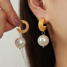 Style: Female Material: Titanium Steel, Imitation Pearl Pearl Type: Uncultured Pearl Color: White Pearl Shape: Round Earring Size: 2*4.13cm Earring Weight: 16g Trendy Metal Pearl Drop Earrings, Elegant Pearl Earrings Made Of Alloy, Elegant Alloy Hoop Earring, Trendy Gold Metal Pearl Earrings, Gold Alloy Pearl Earrings For Party, Metal Pearl Earrings With Plating, Dangle Pearl Earrings In Metal, Round Earring, Pearl Types