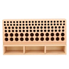 a wooden peg board with holes in the middle and three sections on each side for storage