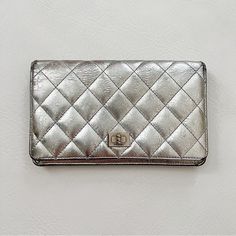 Chanel 2.55 Metallic Wallet In Silver Featuring 8 Card Slots, Coin Zip Pocket And Several Other Slots. Distressed Aged Calfskin On Leather Intentional. Vintage Condition. Minor Scuffs And Signs Of Age, See Pics. Appears As Though Zipper Pull Was Replaced. Unbranded Silver Chain Included. Card Of Authenticity Included. Authenticated By Entropy When I Purchased. Poshmark Authenticates Any Purchase Over $500 Measurements (Approx.): 7.25” W X 4.25” H X 0.75” D Silver Chanel Clutch, Chanel 2, Chanel Bag, Card Slots, Silver Chain, Calf Skin, Slots, Zip Pockets, Coin