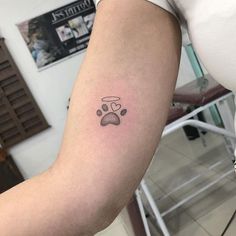 a person with a dog paw tattoo on their arm