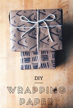 a wrapped gift sitting on top of a wooden table with the words diy wrapping paper