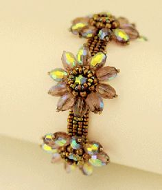 the bracelet is adorned with swaroza beads and glass flowers on it's side