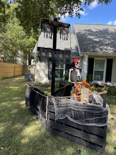 a halloween decoration in the yard with a skeleton sitting on top of an old wooden crate