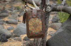 Our 'Tyler' burnt brown festival pouch is a must-have accessory for many occasions, festivals, girls' nights out or everyday shopping.   The pIt is a perfect all-in-one pouch that adds boho touches with its detailed leather mandala feature and turquoise backing. It is super practical with its crossbody strap and space for cards, money, and tickets while your phone is safe in its separate front pocket.   * Separate phone pocket with magnetic enclosure * 12 Card slots, Including ID slot * Zip clos Bohemian Brown Shoulder Bag With Zipper Pocket, Leather Mandala, Custom Leather Bag, Leather Bag Handmade, Bag With Pockets, Handmade Leather Bag, Hidden Colors, Pocket Notes, Bag Handmade