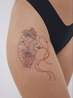 a woman with a tattoo on her thigh